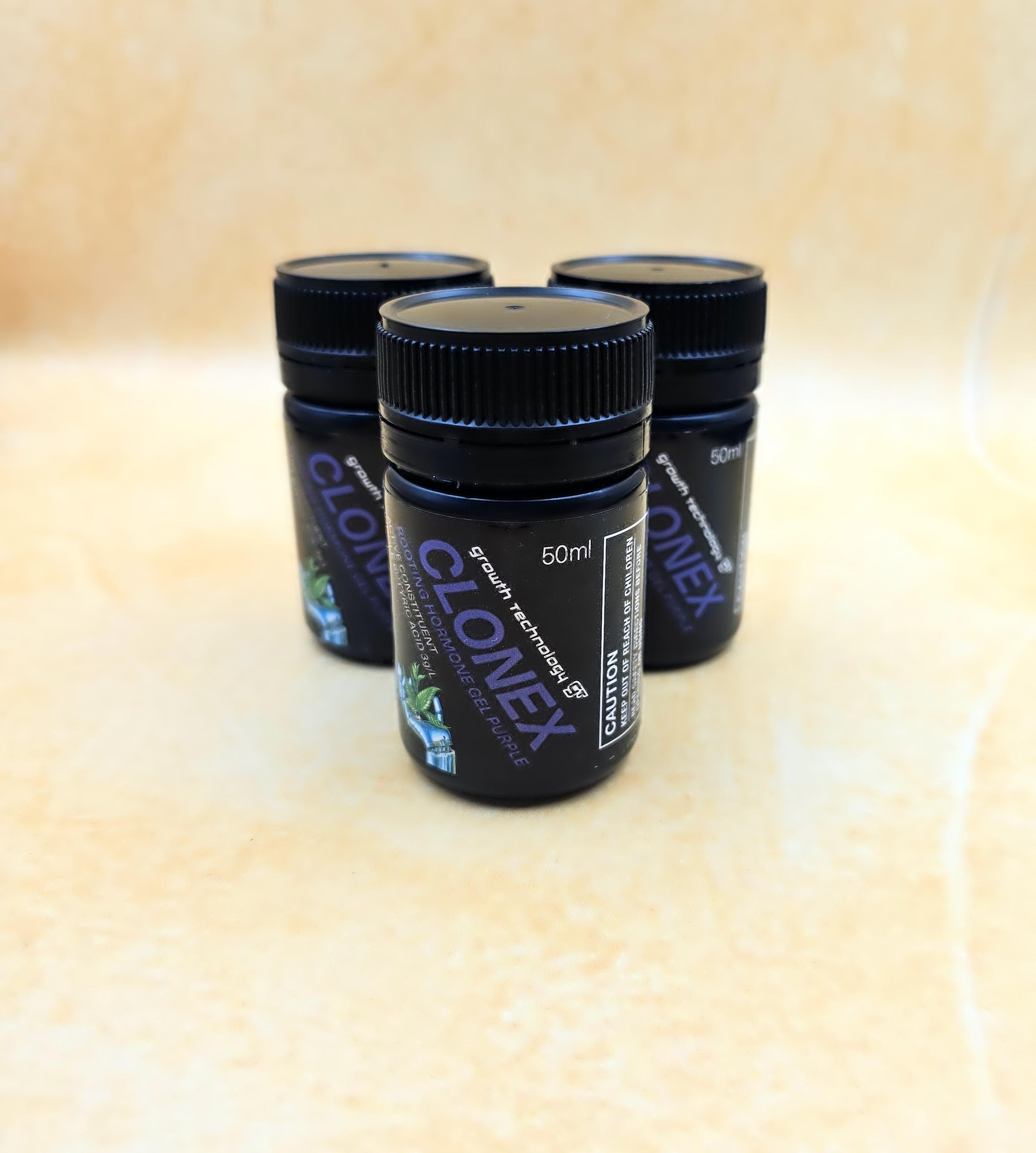 Three Clonex containers on a beige surface